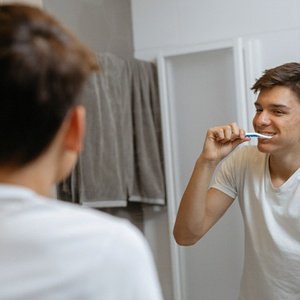 Man brushes his teeth to prevent dental emergencies in Landrum