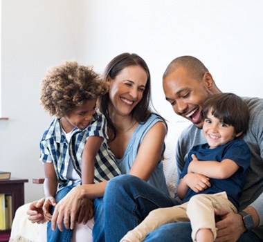 a happy family sitting on a couch