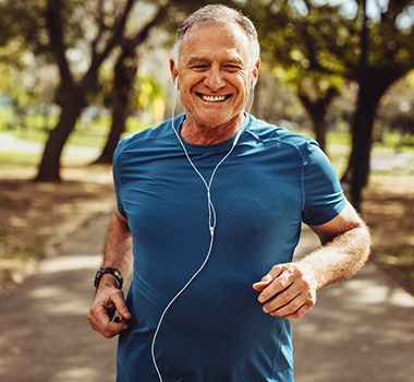 Older man jogging through park with dentures in Landrum, SC