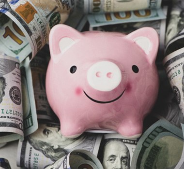 Piggy bank on a pile of cash
