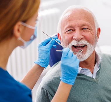 Man smiles at dental hygienist