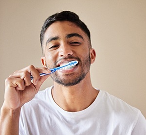man brushing his teeth
