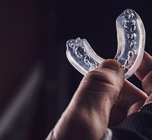 hand holding a mouthguard