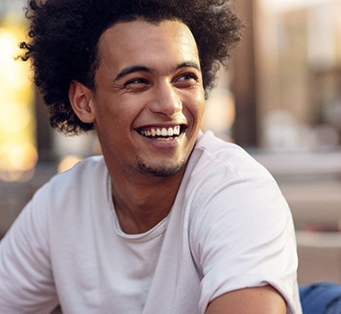 Close-up of man sitting down and smiling