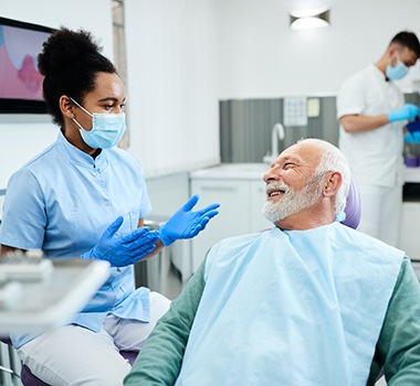 Man in the dental chair listening to his dentist