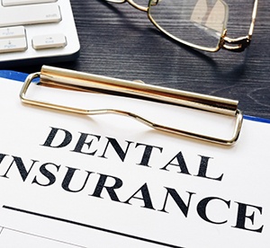 Dental insurance paperwork on black wooden desk 