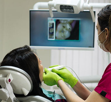 Dentist and patient looking at intraoral photos