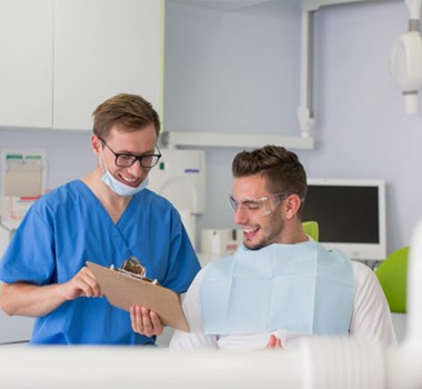 Dentist and patient discussing treatment options