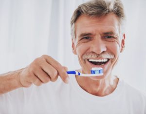 man holding toothbrush