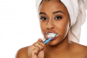 attractive woman smiling brushing teeth