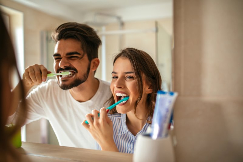 couple brushing their teeth together