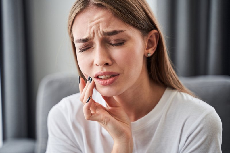 A woman in pain from cavities