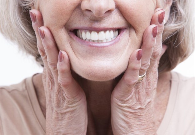 smiling older person wearing dentures