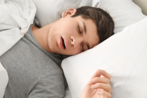 a person breathing heavily through their mouth while sleeping
