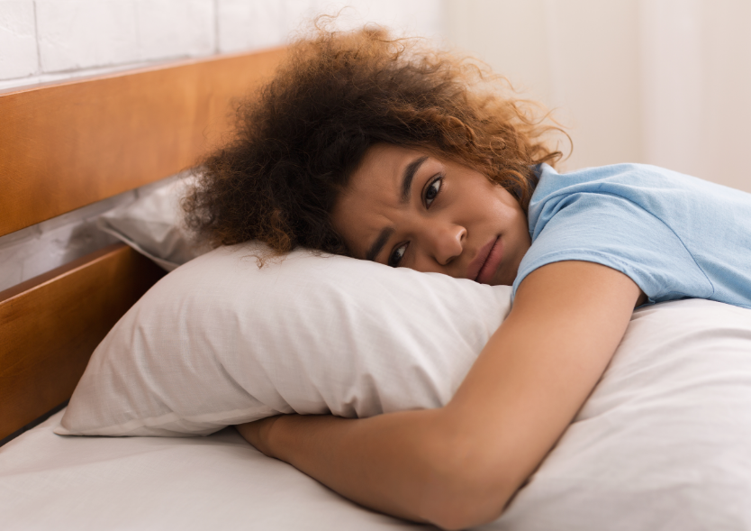 Woman trying to sleep, holding pillow