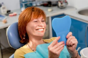 Woman smiling with her new dentures