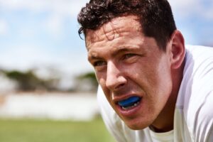 Sweaty athlete wearing mouthguard.